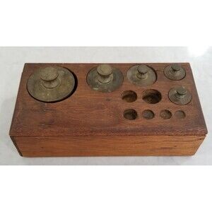 Antique brass weights in wood block incomplete set